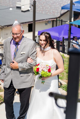 Bride and father walking into gazebo